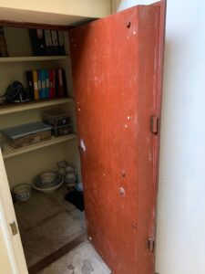 Opened book cupboard door.